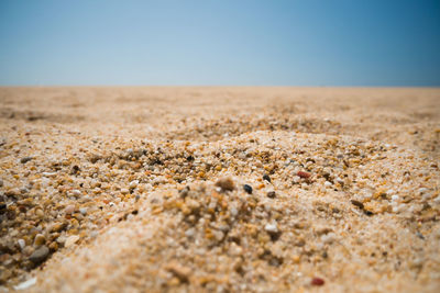 Surface level of desert against clear sky