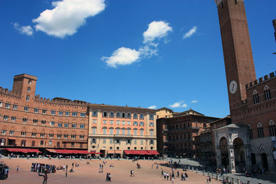 The medieval piazza del campo di siena and the red civic tower of the town hall