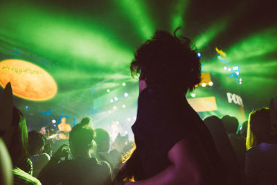 View of illuminated woman in dark