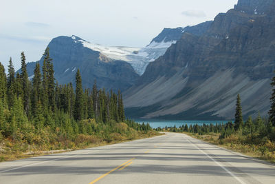 Road amidst mountains against sky