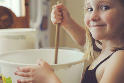 Portrait of girl preparing food in kitchen