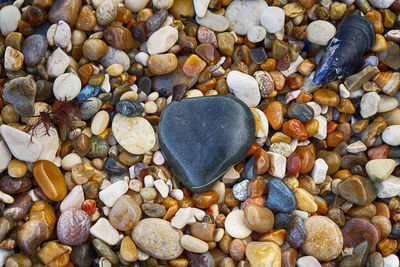 High angle view of pebbles at beach