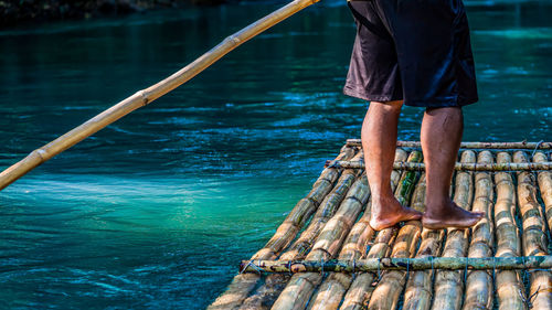 Punting down a river on a bamboo raft