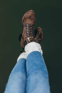 Low section of woman with legs crossed at ankle against water