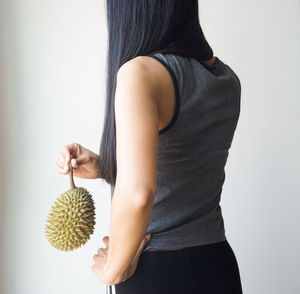 Midsection of woman standing against white background