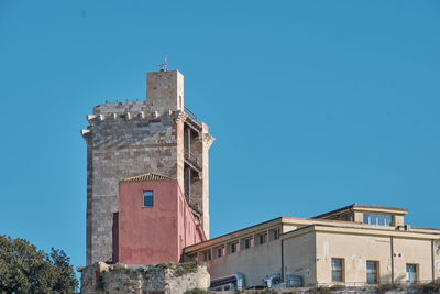 Low angle view of building against clear blue sky