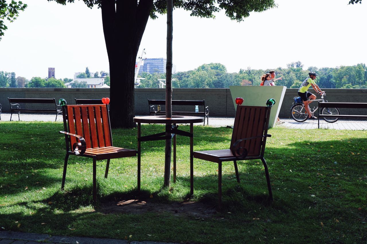 plant, seat, tree, chair, nature, grass, table, park, day, park - man made space, bench, relaxation, architecture, sky, outdoors, backyard, furniture, empty, green, sitting, built structure, leisure activity, lawn, men, absence, adult