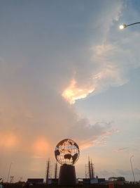 Low angle view of ferris wheel against sky during sunset