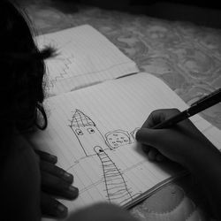 Cropped image of woman reading book