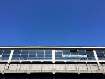 Low angle view of kottbusser tor against clear blue sky