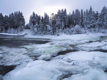 Scenic view of frozen river against clear sky