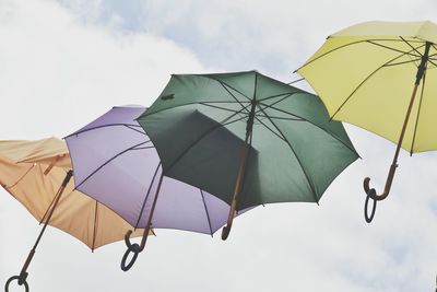 Low angle view of umbrellas against sky