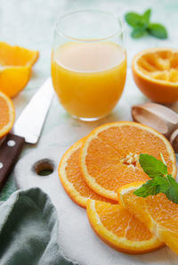 Glass of fresh orange juice with fresh fruits