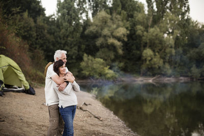 Senior couple embracing at a lake