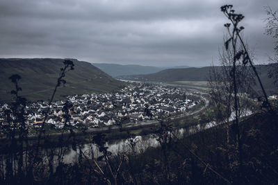 Panoramic view of landscape and mountains against dark winter sky