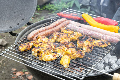 Fried sausages, chicken wings and grilled peppers.