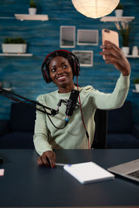 Woman taking selfie at studio