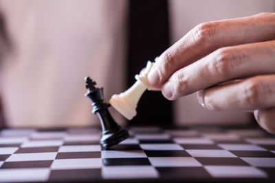 Midsection of man playing chess