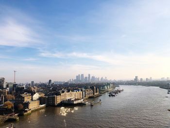 Panoramic view of bay and buildings against sky