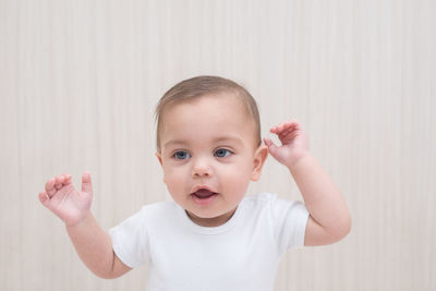 Cute baby boy against wall