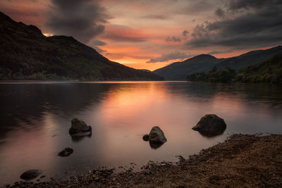 Scenic view of lake against sky during sunset