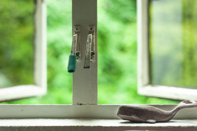 Close-up of door handle on window