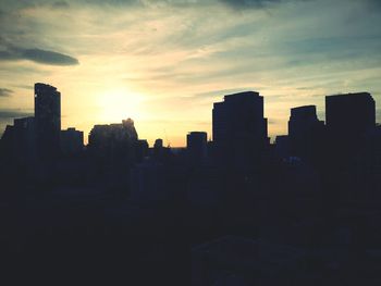 Silhouette of cityscape at sunset