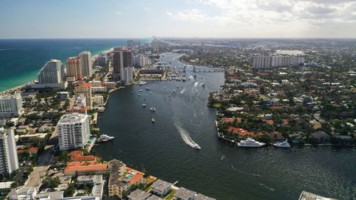 High angle view of buildings by sea against sky