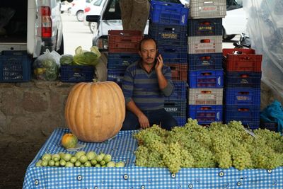 Portrait of woman for sale at market stall