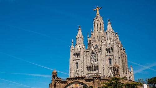 Low angle view of building against blue sky