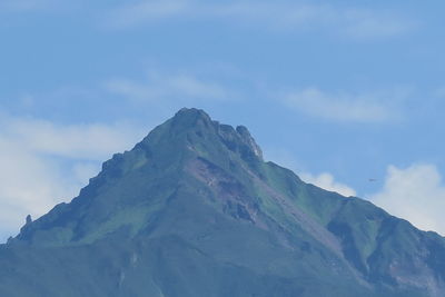 Low angle view of snowcapped mountains against sky