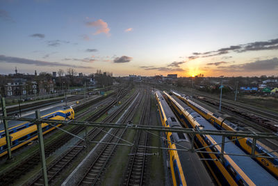 Dutch trains caught from a bridge at sunset