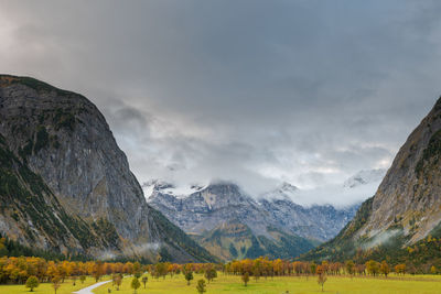 Scenic view of field and mountains against sky