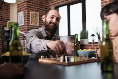 Business colleagues playing chess at office