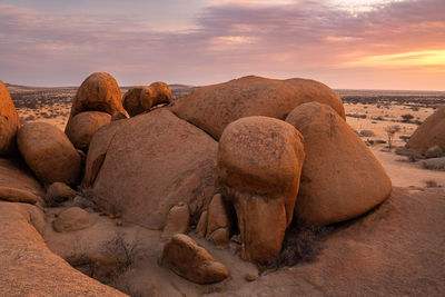 Scenic view of rocks against sky during sunset
