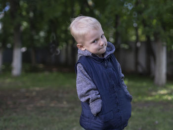 Portrait of cute boy with hands in pockets