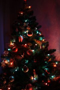 Low angle view of christmas tree at night