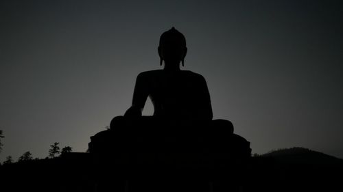 Silhouette of temple against sky
