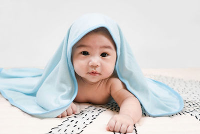 Portrait of cute baby on bed