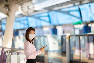 Woman standing on mobile phone