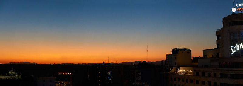 Silhouette buildings against sky during sunset