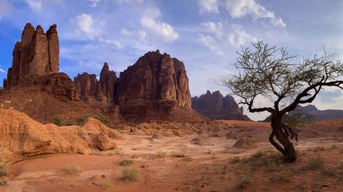 Rock formations on landscape against sky