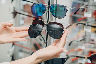 Close-up of woman hand holding sunglasses