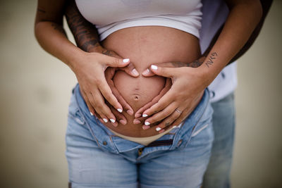 Mixed race couple, close up of baby belly