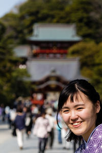 Portrait of smiling woman in city