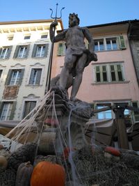 Low angle view of statue against building