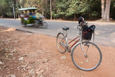 Bicycle parked on road in city