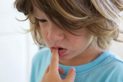 Close-up of boy with finger in mouth