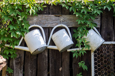 Close-up of shoes on wooden fence