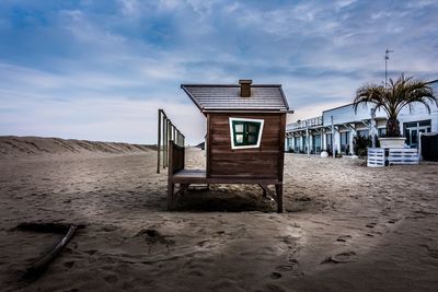 Lifeguard hut on beach against sky